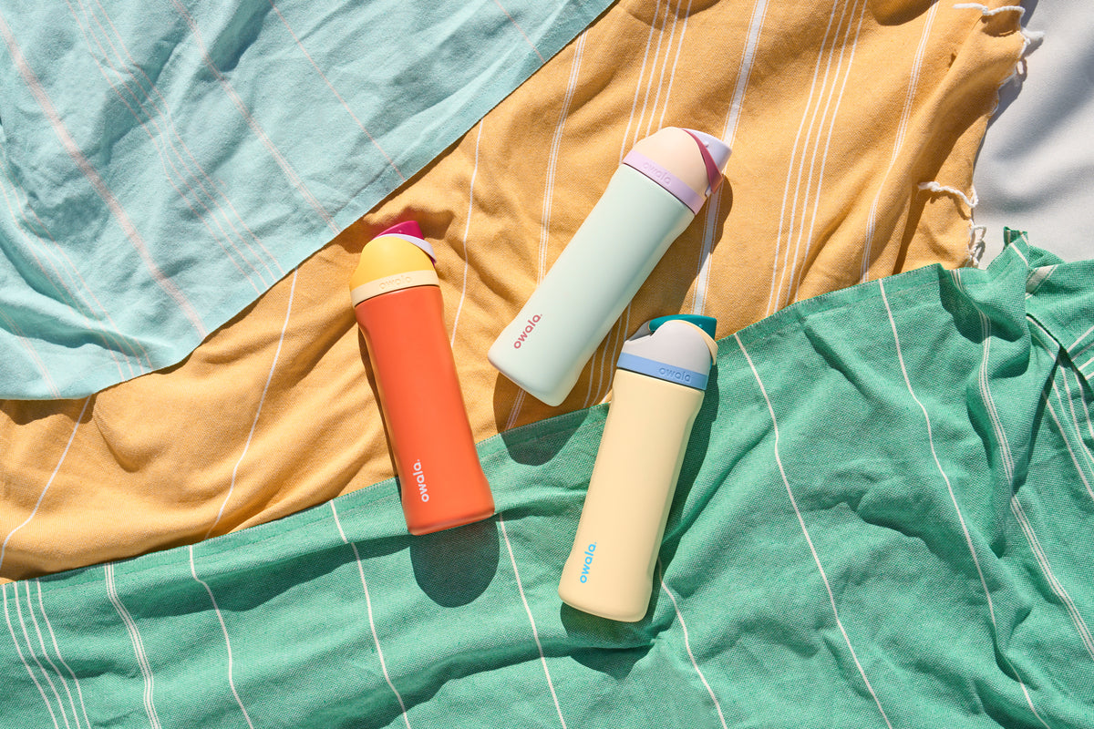 three water bottles laid on towels