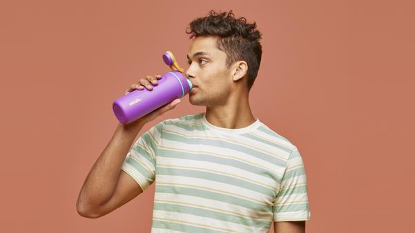 Young man drinking from a purple Owala water bottle, showcasing the Owala drinkware collection designed for staying hydrated with ease. Discover hydration tips and wellness insights on how Owala makes drinking water simple, stylish, and sustainable.