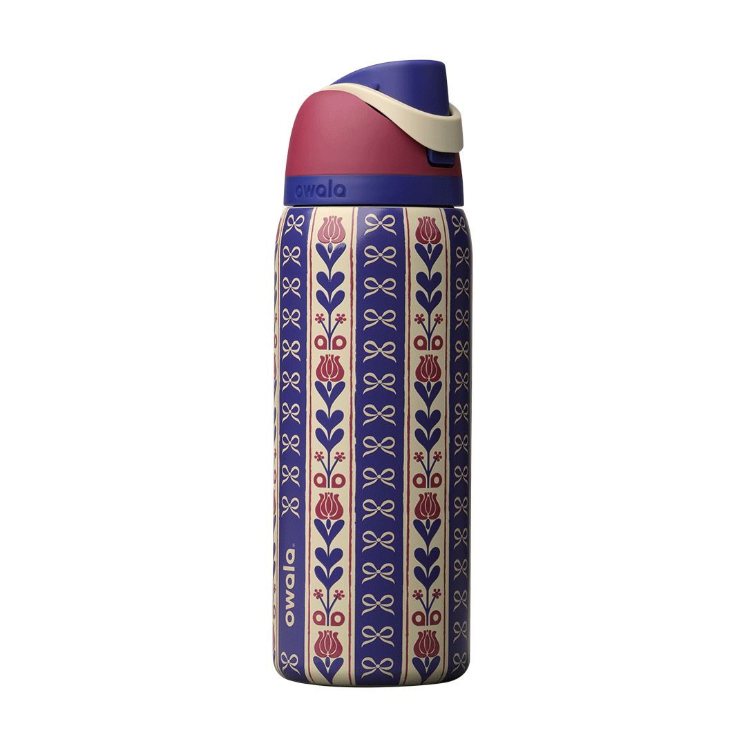 FreeSip 32oz Holiday Hygge; rotating view of cream and navy blue striped body with vertical floral motifs of red tulips and navy bows in a folk-art pattern, dusty rose flip cap, cream carry loop, and navy blue lid
